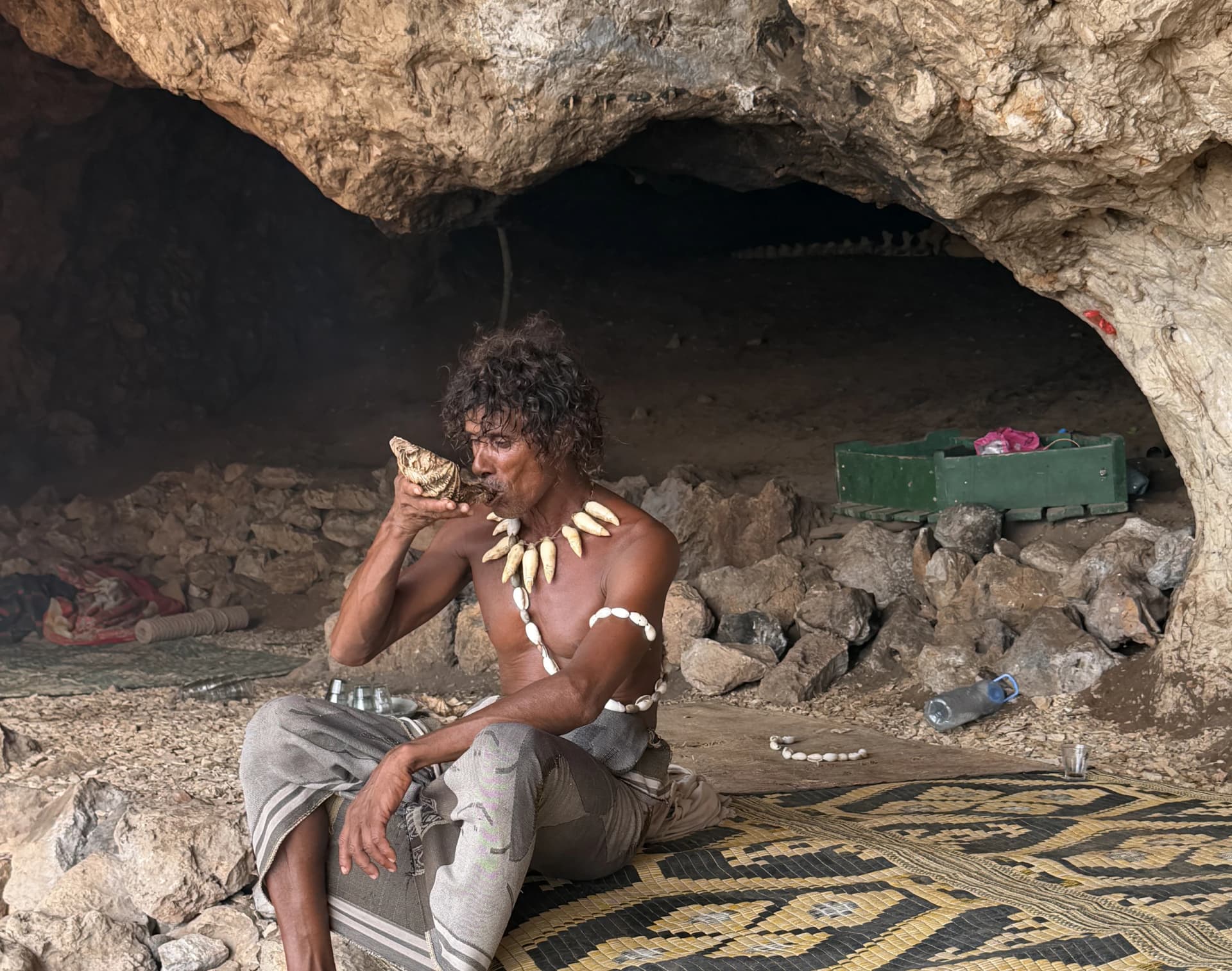 Socotri man standing outside his cave home